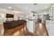 Open concept kitchen and living room with white cabinets and bar area at 18846 Tracer Dr, Lutz, FL 33549