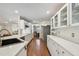 Bright kitchen featuring white cabinetry, quartz countertops, stainless steel appliances, and a view of the dining room at 18846 Tracer Dr, Lutz, FL 33549