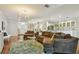 Open concept living room with hardwood flooring connecting the kitchen and living space at 18846 Tracer Dr, Lutz, FL 33549