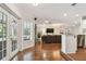 Open-concept living room featuring hardwood floors, natural light, and a view to the kitchen and seating area at 18846 Tracer Dr, Lutz, FL 33549