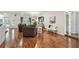 Bright living room featuring hardwood floors, chandelier, and plush seating, great for relaxing or entertaining at 18846 Tracer Dr, Lutz, FL 33549