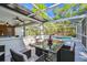 Outdoor patio area featuring a dining table set, bar and seating area, with a pool view at 18846 Tracer Dr, Lutz, FL 33549