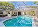 Beautiful in-ground pool area featuring a screened enclosure and a spacious patio at 18846 Tracer Dr, Lutz, FL 33549