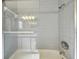 Clean shower with grey tile, a glass door, and modern shower head at 18846 Tracer Dr, Lutz, FL 33549