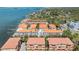 An aerial view shows the waterfront community with tropical landscaping and stunning bay views at 254 Seagate Ct, Dunedin, FL 34698