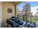 Cozy balcony with comfortable seating and views of lush landscaping at 254 Seagate Ct, Dunedin, FL 34698