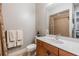 Cozy bathroom with wood cabinets, white sink and tile surround shower with curtain at 254 Seagate Ct, Dunedin, FL 34698