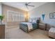 Bedroom featuring light walls, shutters, ceiling fan, and stylish furnishings at 254 Seagate Ct, Dunedin, FL 34698