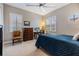 Well-lit bedroom features a ceiling fan, shutters, and cozy furniture at 254 Seagate Ct, Dunedin, FL 34698