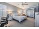 Spacious bedroom featuring neutral walls, carpet, ceiling fan, shutters, and a walk-in closet at 254 Seagate Ct, Dunedin, FL 34698