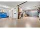 Spacious garage featuring an epoxy floor, overhead storage, and ample workspace at 254 Seagate Ct, Dunedin, FL 34698