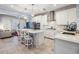 Open kitchen offers an island with seating, stainless appliances, and modern white cabinetry at 254 Seagate Ct, Dunedin, FL 34698