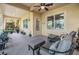 Relaxing lanai with neutral-toned furniture and lush potted plants creating a tranquil outdoor space at 254 Seagate Ct, Dunedin, FL 34698