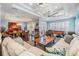 Open-concept living area with a stone fireplace, hardwood floors, and neutral tones at 254 Seagate Ct, Dunedin, FL 34698