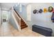 Light-filled entryway features a staircase with wooden treads, white risers, and tiled floors at 254 Seagate Ct, Dunedin, FL 34698