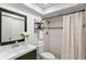 Clean and renovated bathroom featuring a tiled shower and modern vanity at 2650 Countryside Blvd # B102, Clearwater, FL 33761