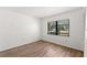 Bright empty bedroom with hardwood flooring at 2650 Countryside Blvd # B102, Clearwater, FL 33761