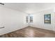 Bright empty bedroom featuring hardwood flooring and two large windows at 2650 Countryside Blvd # B102, Clearwater, FL 33761