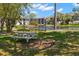 Scenic community area featuring a pond, fountain, picnic table, and lush landscaping at 2650 Countryside Blvd # B102, Clearwater, FL 33761