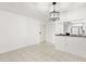 Bright dining room featuring tile flooring and a pass-through to the kitchen at 2650 Countryside Blvd # B102, Clearwater, FL 33761