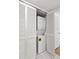 Compact laundry closet with stacked washer and dryer, maximizing space with bi-fold doors at 2650 Countryside Blvd # B102, Clearwater, FL 33761