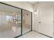 Spacious living area features tile floors, a sliding glass door with a view into the kitchen at 2650 Countryside Blvd # B102, Clearwater, FL 33761