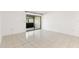 The living room has tile floors, a sliding glass door, and natural light at 2650 Countryside Blvd # B102, Clearwater, FL 33761