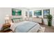 Stylishly staged main bedroom featuring hardwood flooring and bright natural light at 2650 Countryside Blvd # B102, Clearwater, FL 33761