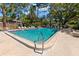 Large community pool with shaded seating area for relaxing with friends at 2650 Countryside Blvd # B102, Clearwater, FL 33761