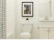 Bathroom with a shower and a toilet with a neutral painting as decoration at 31794 Griffin Sands Ln, San Antonio, FL 33576