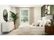 Bright bedroom featuring a large window, modern decor, and a comfortable bed at 31794 Griffin Sands Ln, San Antonio, FL 33576
