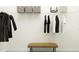 This walk-in closet features a wire shelving system, hanging clothes, and a bench at 31794 Griffin Sands Ln, San Antonio, FL 33576