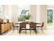 A dining room features a table with six chairs and a sideboard with decorative lamps and a large vase with greenery at 31794 Griffin Sands Ln, San Antonio, FL 33576