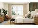 Cozy bedroom with neutral tones and a comfortable bed near two big windows at 31794 Griffin Sands Ln, San Antonio, FL 33576