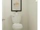 Simple toilet with neutral colors and a modern wall decoration at 31794 Griffin Sands Ln, San Antonio, FL 33576