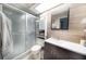 Updated bathroom featuring a shower, vanity with modern finishes, and unique shiplap accent wall at 3219 Spanish Moss Ln, Palm Harbor, FL 34684