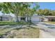 Charming single-story home with a well-maintained lawn and mature trees, providing curb appeal at 3219 Spanish Moss Ln, Palm Harbor, FL 34684