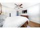 Cozy main bedroom featuring hardwood floors, ceiling fan, dresser, and ample closet space at 3219 Spanish Moss Ln, Palm Harbor, FL 34684