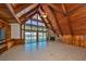 Vaulted living room with a stone fireplace, exposed beams, and expansive water views at 352 Shore E Dr, Oldsmar, FL 34677