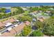 Aerial view of the property featuring a community pool, tennis courts, and mature trees at 3632 Pine Cone Cir, Clearwater, FL 33760