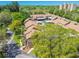 A high aerial view of condos nestled within mature trees in a well maintained community at 3632 Pine Cone Cir, Clearwater, FL 33760