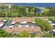 Aerial view of a townhouse community with a golf course and waterfront views in the background at 3632 Pine Cone Cir, Clearwater, FL 33760