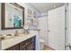 Bathroom featuring granite counters, updated vanity, and a shower with curtain at 3632 Pine Cone Cir, Clearwater, FL 33760