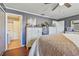 Bedroom with wood floors, ceiling fan, and bathroom access at 3632 Pine Cone Cir, Clearwater, FL 33760