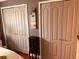 Bedroom with multiple closets and plenty of storage space; enhanced by palm tree artwork and a small dresser at 3632 Pine Cone Cir, Clearwater, FL 33760