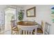 Dining area with a wooden table and chairs near the kitchen and living spaces at 3632 Pine Cone Cir, Clearwater, FL 33760