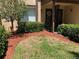 Lovely townhome exterior with lush landscaping, mature trees, and a charming covered entrance at 3632 Pine Cone Cir, Clearwater, FL 33760