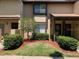 Charming townhome with well-manicured front lawn, mature landscaping, and covered entryway at 3632 Pine Cone Cir, Clearwater, FL 33760