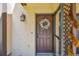This exterior shot features an inviting front door with a decorative wreath at 3632 Pine Cone Cir, Clearwater, FL 33760