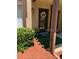 Inviting front porch showcasing a decorative wreath, potted plant, and accent lighting at 3632 Pine Cone Cir, Clearwater, FL 33760